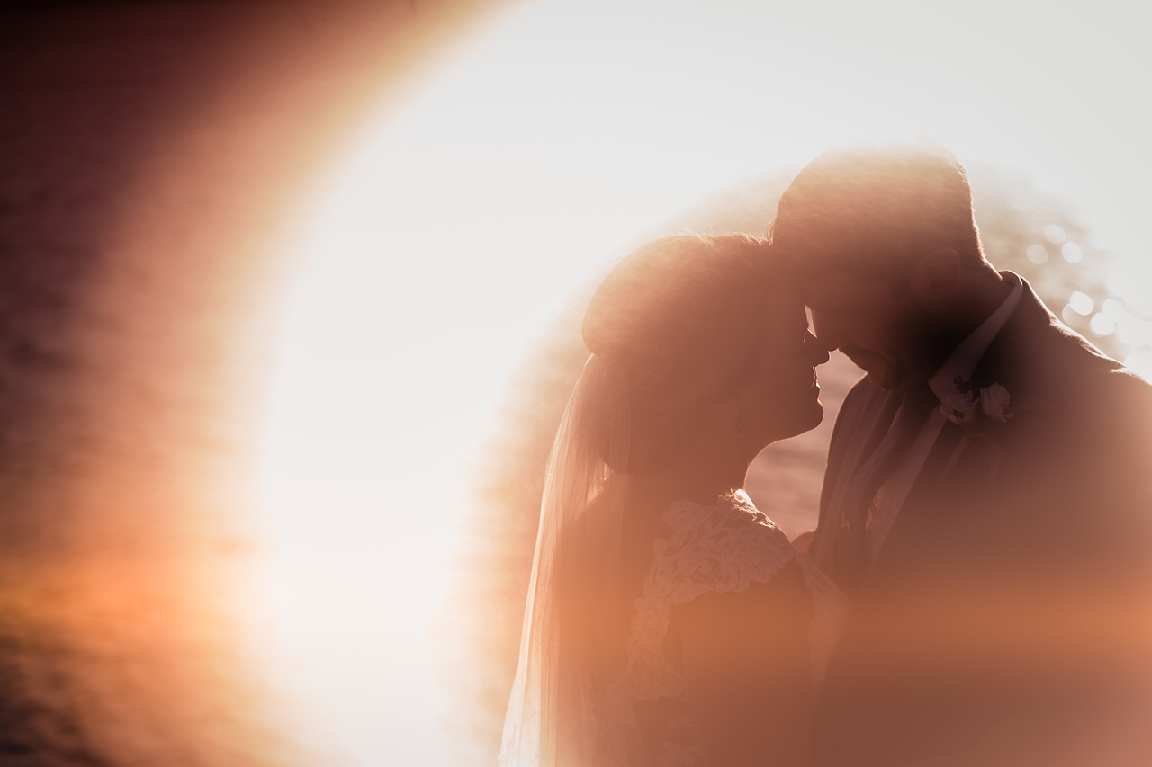 creative image in peach and white hues of couple in romantic moment