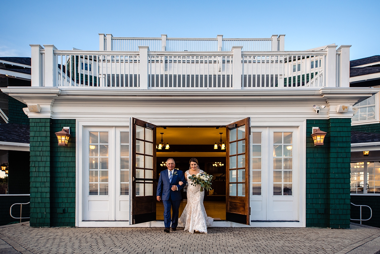 bride and her father emerging from the venue to walk down the aisle for wedding ceremony