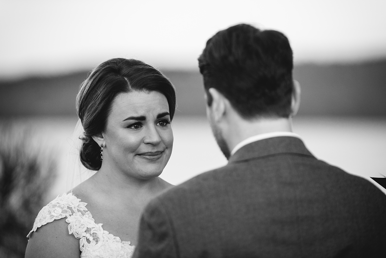 bride looking at groom and starting to cry during ceremony