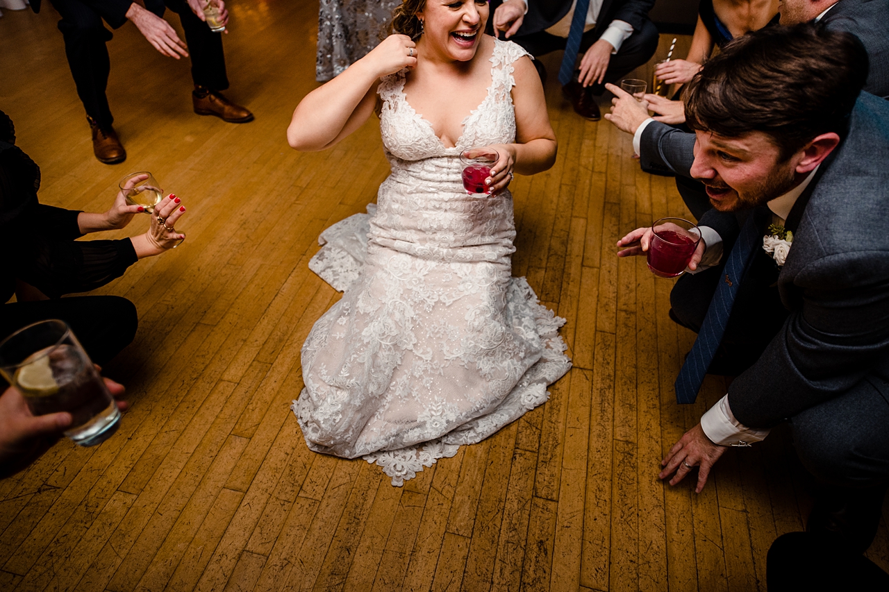 bride on the dance floor holding a red drink