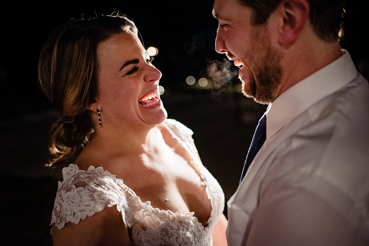 couple laughing at the end of the night outside. Backlighting