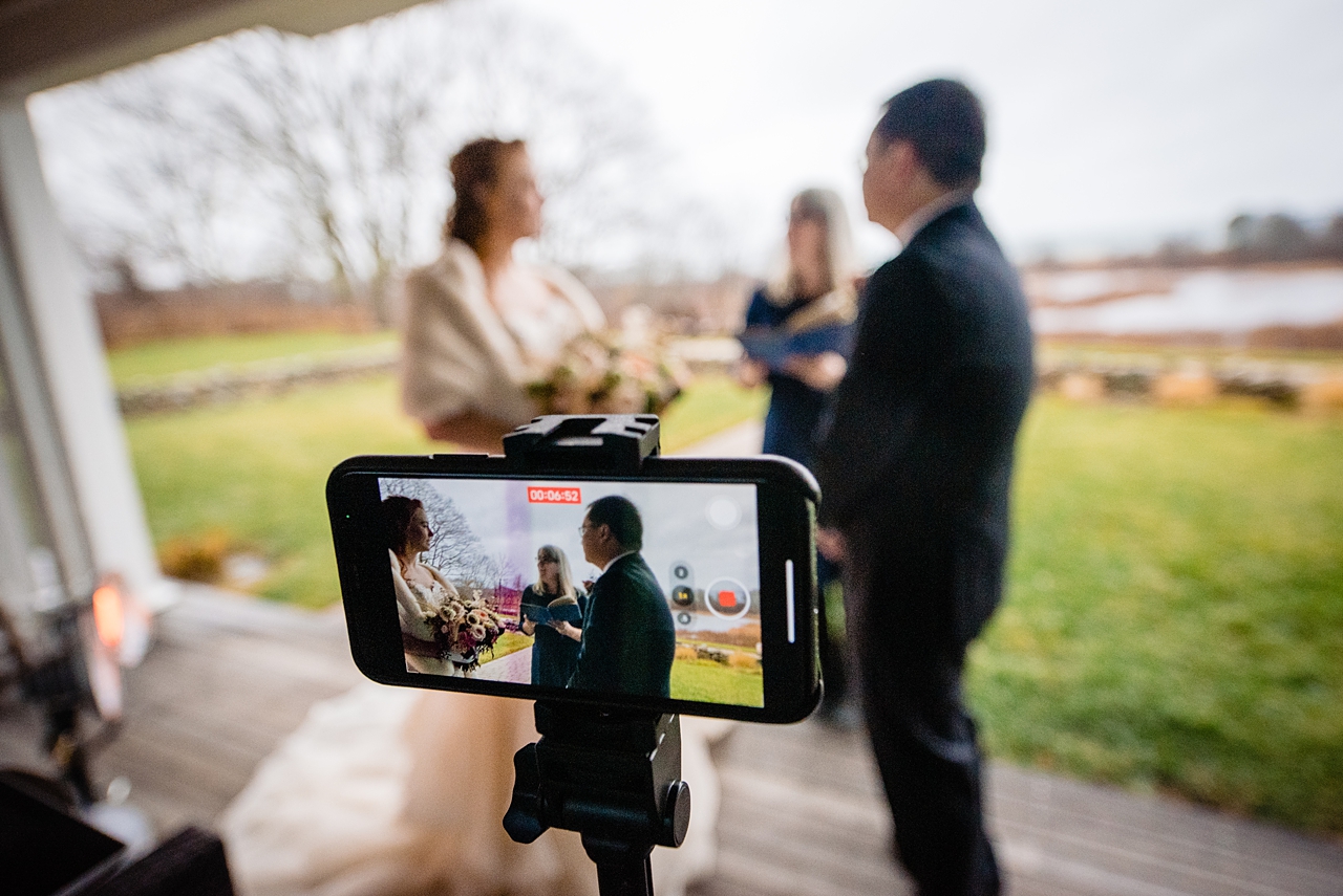 Photo of the back of a cell phone that is recording a wedding ceremony.