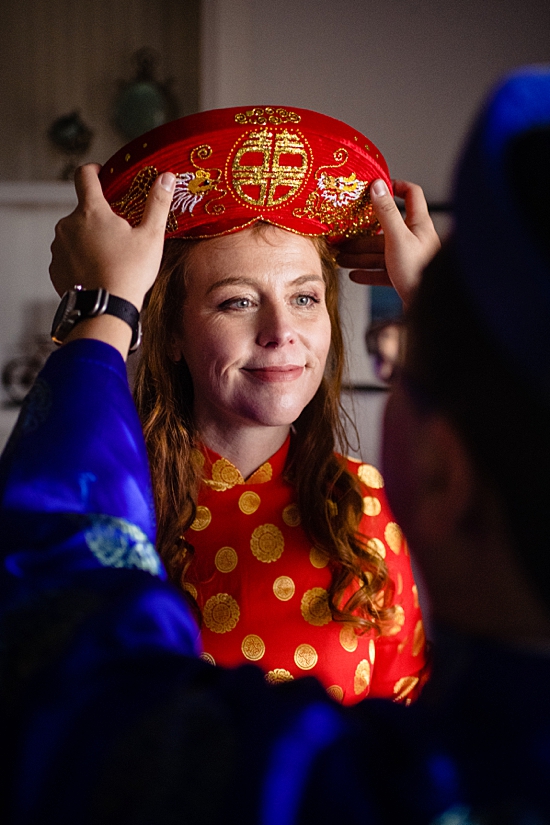 Groom helping bride get ready.